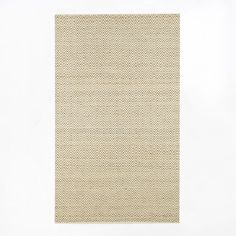 an area rug with white and beige herringbones