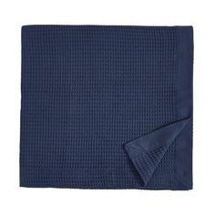 the navy blue blanket is folded on top of a white background