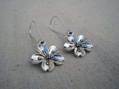 These are unique and beautiful cherry blossom flower earrings.  They are happy and fun.  The charms measure about 5/8" across as well as up and down.  The dangle and dance from 1" long kidney style earwires.  Made from allergy free plated silver.  The over all drop of the earrings is about 1 5/8" long.These are perfect for everyday, year round wear and would also make a very nice gift.Tiger Flower Jewelry - Inspired by Nature Blossom Color Earrings With Flower Charm For Spring, Blossom Flower Charm Earrings For Spring, Blossom Colored Flower Charm Earrings For Spring, Blossom Color Flower Charm Earrings For Spring, Whimsical Spring Flower Earrings With Ear Wire, Whimsical Spring Earrings With Flower Charm, Spring Flower Shaped Nickel Free Earrings, Spring Flower-shaped Nickel-free Earrings, Silver Flower Earrings For Spring Gift