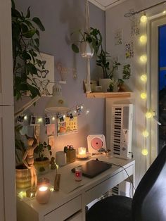 a desk with some plants and lights on it