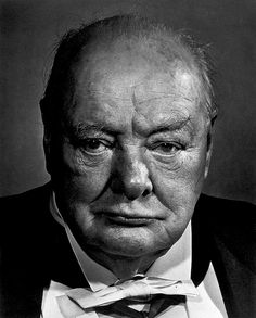 an old man in a suit and tie looking at the camera with a serious look on his face