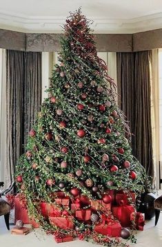 a decorated christmas tree with presents under it