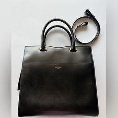 In Excellent Condition. Never Used. It Comes With A Dust Bag. Gold Hard Ware. It Comes With A Strap. Sold As Is. No Returns. Designer Tote Bags For Formal Occasions, Designer Workwear Satchel, Luxury Workwear Bags With Dust Bag, Designer Formal Tote Satchel, Designer Formal Satchel Tote, High-end Black Bags For Workwear, High-end Black Bags For Work, Luxury Workwear Satchel, Luxury Black Bag For Work