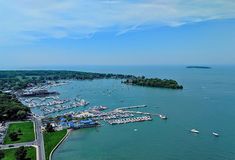 an aerial view of a harbor with many boats in the water and trees on both sides