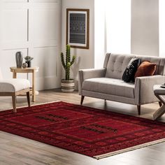 a living room scene with focus on the couch and chair, coffee table and potted plant