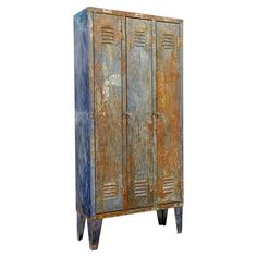 an old, rusty metal cabinet with two doors on one side and three legs on the other