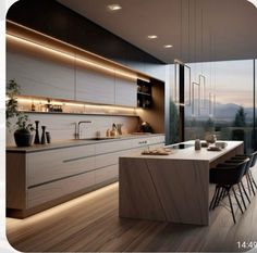 a modern kitchen with wooden floors and white cabinetry is lit by recessed lighting