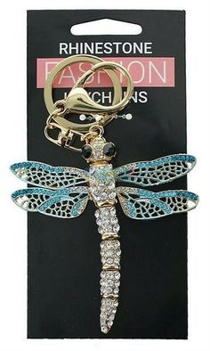 a key chain with a dragonfly on it's front and back ends in gold