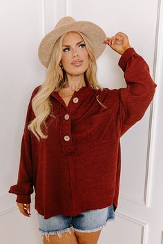 - From the pumpkin patch to the coffee shop, this adorable henley top is full of fall vibes! It's the perfect piece to spice up your cool weather wardrobe and keep you looking on-trend no matter where the day takes you. - Unlined knit material with a ribbed texture and unfinished seam accents - A collared v-cut neckline that buttons down into a three buttoned bodice with wooden buttons - A functional chest pocket - Long, loose sleeves with ribbed cuffs - A relaxed silhouette that ends in a high- Fall Long Sleeve Henley With Buttons, Long Sleeve Henley With Buttons For Fall, Brown Buttoned Tops For Fall, Brown Tops With Buttons For Fall, Fall Long Sleeve Henley, Casual Fall Henley Shirt, Long Sleeve Henley For Fall, Casual Fall Henley, Casual Henley With Buttons For Fall