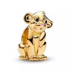 a gold monkey figurine sitting on top of a white surface