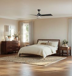 a bed room with a neatly made bed and a ceiling fan in it's corner