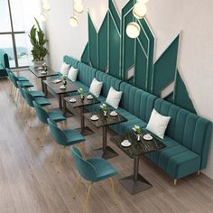 a restaurant with green booths and blue chairs