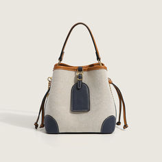 Description:Going out and about in the town is even better with this gorgeous bag! Made of PU leather and canvas. embellished with twin drawstrings to the side. featuring a magnetic buckle closure to the top along with a detachable strap. an interior zipper pocket. Find more trendy women's bucket bags or unique bags in our boutique. and elevate your daily look with our accessories. Size One Size(in) One Size(cm) Length 8.7 22.0 Height 7.9 20.0 Width 4.7 12.0 Beige Canvas Satchel Bucket Bag, Large Capacity Canvas Pouch Bucket Bag, Large Capacity Canvas Bucket Bag, Beige Canvas Bucket Shoulder Bag, Canvas Crossbody Bucket Bag For On-the-go, Bucket Canvas Bag For Errands, Cream Canvas Bucket Shoulder Bag, Canvas Crossbody Bucket Bag, Canvas Bucket Bag Crossbody For On-the-go