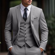 a man in a gray suit and tie