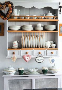 a china cabinet with dishes and cups on it