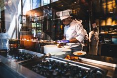 a chef preparing food in a restaurant kitchen