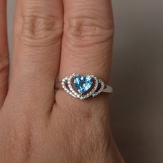 This is a gorgeous handmade creation. Its beauty is its simplicity & Elegance. The 6*6 mm heart cut faceted real Swiss Blue Topaz is crafted in solid sterling silver and with rhodium plated. All item is sent in a beautiful gift box If you have any idea of design your ring,pls contact me directly. You can realize more lovely stuff clicking the link https://www.etsy.com/shop/knightjewelry?refshopsection_shophome_leftnav Please leave the correct address and you phone number for delivering succe Blue Heart Cut Ring For Gift, Blue Topaz Heart Cut Promise Ring, Silver Heart Cut Topaz Ring Gift, Gift Topaz Ring With Accent Stones, Heart Cut, Heart-shaped Topaz Ring For Gift, Heart Wedding Rings, Swiss Blue Topaz Ring, Swiss Blue Topaz, Wedding Rings Unique