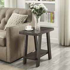 a living room with a couch, coffee table and bookshelf