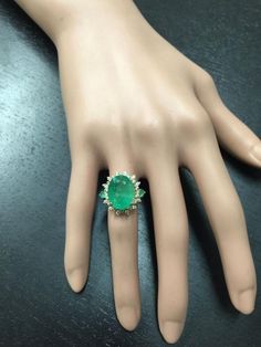 6.42 Carats Natural Emerald and Diamond 14K Solid Yellow Gold Ring Suggested Replacement Value: $7,900.00 Total Natural Green Emerald Weight is: 5.67 Carats Emerald Measures: 13.90 x 10.76mm Natural Round Diamonds Weight: .75 Carats (color G / Clarity SI1) Ring total weight: 5.8 grams Disclaimer: all weights, measurements and colors are approximate and may vary slightly from the listed dimensions or as seen in the image. All pictures are magnified to show the smallest of details. Please, refer t Luxury Pear-shaped Emerald Ring For Formal Occasions, Elegant Green Gia Certified Gemstones, Elegant Green Gemstones For Formal Occasions, Dazzling Green Diamond Ring For Formal Occasions, Luxury Green Emerald Ring For Formal Occasions, Formal Green Pear-shaped Diamond Ring, Dazzling Green Rings For Formal Occasions, Green Dazzling Rings For Formal Occasions, Formal Green Dazzling Rings