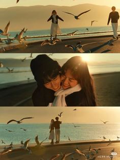 two people standing next to each other with seagulls flying over them and birds in the air