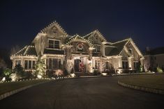 a large house covered in christmas lights at night