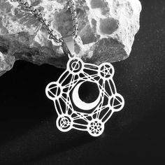 Unlock the divine energies of the universe with our captivating Archangel Metatron Cube Flower of Life Moon Necklace! 🌙✨ This exquisite piece of metaphysical jewelry combines the sacred symbols of the Metatron's Cube, the Flower of Life, and the phases of the moon, creating a powerful talisman for your spiritual journey. Crafted with utmost care and attention to detail, this necklace features a stunning pendant that showcases the intricate Metatron's Cube, a sacred geometric pattern that is bel Supernatural Jewelry, Metatron Cube, Sacred Geometric Pattern, Mystical Necklace, Wiccan Necklace, Archangel Metatron, Enchanted Jewelry, Metatron's Cube, Spiritual Necklace