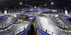 an indoor skateboard park with ramps and ramps for people to ride down the hill