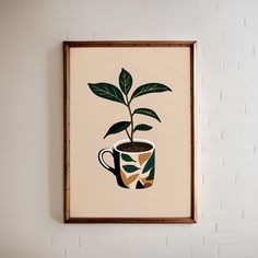 a plant in a coffee cup is hanging on the wall