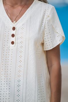 Refresh your look with this Beige Eyelet Tulip Sleeve V-Neck Top. The delicate eyelet detailing and charming tulip sleeves combine for a soft, feminine flair that’s perfect for any sunny day outing. Product code: CAA04C4G011CC Features:  Knit V-neckline Partial front buttons Short tulip sleeves Material: 92%POLYESTER,8%SPANDEX. Casual V-neck Eyelet Blouse, Feminine Eyelet Tops For Summer, Feminine Summer Tops With Eyelet Details, Summer V-neck Top With Broderie Anglaise, Summer Short Sleeve Tops With Broderie Anglaise, Summer V-neck Top With Eyelet Detail, Summer V-neck Eyelet Top, Feminine Summer Eyelet Blouse, Chic Eyelet Top For Summer