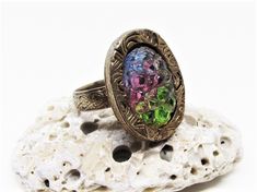 "A cool vintage 1960's / 1970's hippie era rainbow crystal ring. The ring is gold plated metal with an adjustable floral band and ornate spiral etched mount. The centerpiece of the design is a super unique oval shaped, rainbow striped, German sugar crystal in lime green, baby pink and sky blue. The crystal reminds me of a bed of raw crystals in nature, with bumpy gleaming facets. A super rare, fun ring, sure to make a statement! Gift boxed and ready for gift giving. -Age: Late 1960's / early 197 Vintage Multicolor Rings As Gift, Vintage Multicolor Rings For Gift, Vintage Multicolor Rings For Jewelry Making, Vintage Multicolor Rings For Gifting, Vintage Multicolor Rings For Gifts, Vintage Crystal Ring As Gift, Adjustable Multicolor Vintage Rings, Vintage Adjustable Metal Rings, Multicolor Adjustable Vintage Rings