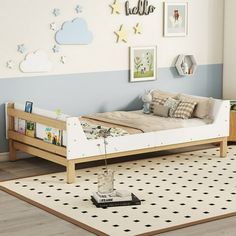 a child's bedroom with blue and white walls, wooden furniture and pictures on the wall