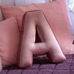 the letter a is made out of pink pillows