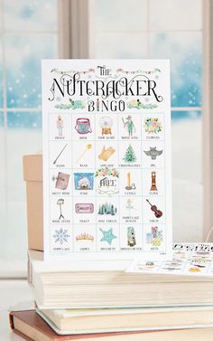 the nutcracker bingo game sits on top of a stack of books next to a window