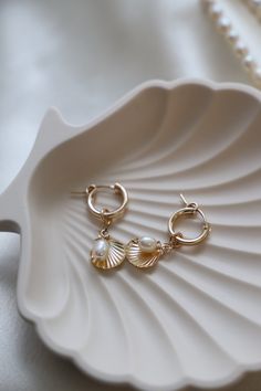 Featuring gold filled hoops adorned with a freshwater pearl and a charming gold filled shell dangle, these earrings will add a touch of seaside style to any outfit. Perfect for beach babes Material: Gold filled, freshwater pearls Size: 13mm hoop, 11mm shell dangle, organic shape rice pearl (size may vary) Bachelorette Party Dress, Champagne Dress, Seaside Style, Rehearsal Dinner Dresses, Gold Filled Hoops, Rehearsal Dress, Multicolor Dress, Maxi Dress Wedding, Silver Dress