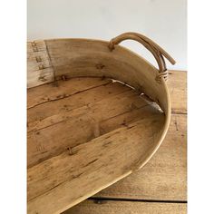 an old wooden bed frame with curved slats on the top and bottom, sitting on a wood floor