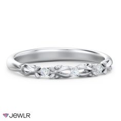 a white gold wedding band with three diamonds on the side and an intertwined design