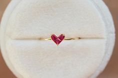 A minimalism dainty heart shape ruby ring made with solid 14k or 18k gold. Easy to be stacked with other rings or wear on its own. The heart shape is very symbolic, give your heart to someone you love.  💎PLEASE READ DETAIL RETURN AND EXCHANGE POLICY IN OUR SHOP'S "Frequently asked questions" SECTION 💎 💎 Metal: 14k gold/14k white gold/14k rose gold, 18k gold/18k white gold/18k rose gold 💎 Stone: Natural genuine ruby total around 0.23 ct 💎 Band width around 1.2 mm  We recommend to try the rin Ruby Heart Ring, Heart Engagement Ring, Gemstone Wedding Ring, Heart Engagement, July Birthstone Ring, Gemstone Wedding, Gemstone Wedding Rings, Ruby Heart, Heart Engagement Rings