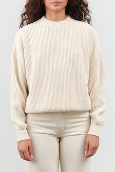 The Konan Sweater is a beautiful crewneck pullover with ribbed details throughout. It has a standard easy fit, gently tapering at the hem. With a slightly dropped shoulder and double ribbed neckline, this sweater exudes a chic and stylish look. Layering Turtleneck Sweater With Ribbed Neckline, Turtleneck Sweater With Ribbed Neckline For Layering, Oversized Ribbed Crew Neck Cropped Sweater, Oversized Ribbed Cropped Sweater With Crew Neck, Cream Ribbed Crew Neck Sweater, Classic Oversized Ribbed Sweater, Classic Oversized Sweater With Ribbed Neckline, Classic Relaxed Fit Ribbed Sweater, Classic Ribbed Sweater For Everyday