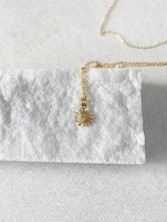 "This solid 14k gold charm is stunning and has a great detail. The slightly curved sun beams and its dome shape add dimension. The pendant measures approximately 8 mm. Now available with the 16 or 18\" dainty solid 14k gold chain. The sun will be suspended on 4 mm open bail (see 1st photo) If you only purchasing the charm, select bail size: 4 mm 14k open jump ring bail and can accommodate chains up to 1.6 mm. 6 mm 14k closed bail that can suit thicker necklaces. Hallmarked 14K 14k sand dollar ch Dainty Sun Design Jewelry For Everyday Wear, Dainty Sun Design Jewelry For Everyday, Dainty Everyday Sun Design Jewelry, 14k Gold Necklaces With Sun Design, 14k Gold Sun Design Necklaces, 14k Gold Sun Design Necklace, Celestial Yellow Gold Charm Necklaces For Gifts, 14k Yellow Gold Jewelry With Flower Charm, 14k Gold-filled Yellow Gold Flower Pendant Jewelry