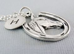 "A horse lovers necklace... This detailed solid sterling silver horse/horseshoe charm dangles from a sterling silver chain. A small round tag/charm sways alongside with a hand stamped initial. The horse/horseshoe charm measures 20 x 13.5mm (13/16\" x 9/16\") and the small hand stamped initial tag measures 9mm (3/8\"). The chain comes in a (14\", child\"s length), 16\", 18\" and 20\" inch lengths to choose from during checkout. If you have any questions, please do not hesitate to contact me. Than Silver Horseshoe Charms Jewelry, Personalized Silver Horseshoe Jewelry, Silver Horseshoe Jewelry Gift, Silver Horseshoe Necklace Nickel Free, Nickel-free Silver Horseshoe Necklace, Silver Sterling Silver Jewelry For Shows, Nickel-free Horseshoe Sterling Silver Jewelry, Nickel-free Silver Horseshoe Jewelry, Horse Necklace