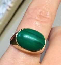 this Mans vintage ring is bezel set with natural Malachite large cabochon. set in yellow solid 14k gold. the ring is large and well built and the band is thick as well. So can be sized if needed. hallmark is 14k and tested.  the weight approx 7.14g the size 8USA  Cabochon approx - 15x11mm properties of malachite:  Malachite clears and activates the chakras and attunes to spiritual guidance. It opens the heart to unconditional love. Encourages risk-taking and change, breaks unwanted ties and outworn patterns, and teaches how to take responsibility for one's actions, thoughts and feelings. it's also known as the power stone. It has been said that malachite puts you on a path of success and prosperity. It can be worn by anyone. Malachite is also a birthstone for Capricorn. The malachite power Classic Green Dome Ring In 14k Gold, Classic Green 14k Gold Dome Ring, Classic Green Cabochon Signet Ring, Classic Green Oval Cabochon Signet Ring, Green Oval Signet Ring Collectible, Mans Ring, Power Stone, Vintage Navajo, Spiritual Guidance