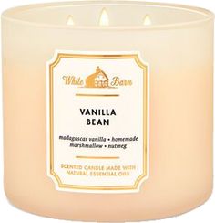 vanilla bean scented candle with an orange label on the front and white wax around it