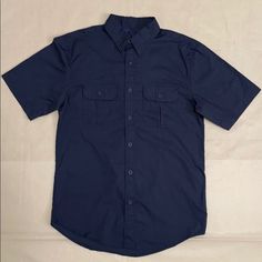 Nwt Utility With Vented Back Basic Editions Short Sleeve Travel Shirt Size: S It's Features: . Point Collar . Button - Front . Short Sleeve Shirt . 60% Cotton / 40% Polyester . Locker Loop On Back Of Shirt . Meshed Lined Vented Back With Velcro Closure . Multifunctional Front Pocket With Flapped Button Closure True Measurements: Size S: Chest : 40" Shoulder To Hem: 28" Note: Color May Vary Due To Camera Non Smoking / Pet Free Home Navy Button-up Shirt, Navy Casual Short Sleeve Shirt With Pockets, Navy Short Sleeve Shirt With Buttons, Navy Short Sleeve Tops With Button Closure, Navy Cotton Button-up Short Sleeve Shirt, Casual Navy Tops With Snap Buttons, Navy Casual Tops With Snap Buttons, Travel Shirt, Travel Shirts