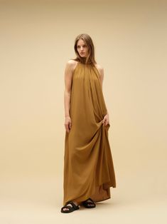 Imagine a dress that effortlessly blends comfort with a captivating wow factor. This statement piece features a flowy silhouette and eye-catching detailing. Crafted in soft, natural, breathable fabric, it can be worn in two ways, adding to its versatility. Available in a variety of colours and print. PRODUCT DETAILS Halter neck design Long maxi dress Versatile wear: can be worn in two ways, either loose or tight around the lower bust Loose fit or wraparound style Bump friendly Low back (elasticated at the back for seamless comfort) Long bow detail at the back for added elegance and style Designed in Australia Soft and light natural fabric Made with ecovero CONSIDERED NATURAL FABRIC Made with Lenzing EcoVero fabric, an eco-friendly sustainable material. EcoVero fabric has a very soft hand f Chic Flowy Maxi Dress For Fall, Flowy Rayon Maxi Dress For Casual Occasions, Flowy Rayon Maxi Dress For Casual Wear, Flowy Silk Pre-draped Maxi Dress, Flowy Viscose Dress For Spring, Flowy Maxi Dress For Fall, Flowy Viscose Dresses For Daywear, Chic A-line Flowy Maxi Dress, Spring Pre-draped Flowy Dress