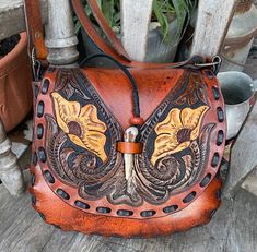 I just finished this bag...I used an old 70s leather pattern to create this one of a kind floral tooled crossbody shoulder bag....I left the strap long plus you can adjust the length I used a deer antler peg for closure... measurements are8 1/2 inches tall, 10 inches wide and the gusset is 2 inchesso this is considered a medium size bag, Artisan Hand Tooled Crossbody Saddle Bag, Bohemian Hand Tooled Saddle Bag, Western Style Hand Tooled Brown Shoulder Bag, Western Style Brown Hand Tooled Shoulder Bag, Vintage Brown Hand-tooled Crossbody Shoulder Bag, Vintage Brown Hand Tooled Crossbody Shoulder Bag, Bohemian Hand Tooled Brown Satchel, Bohemian Hand-tooled Brown Satchel, Bohemian Brown Hand Tooled Satchel