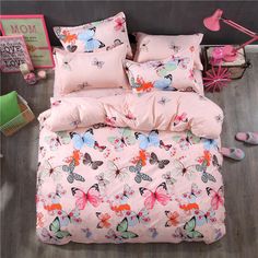 a bed with pink sheets and butterflies on it