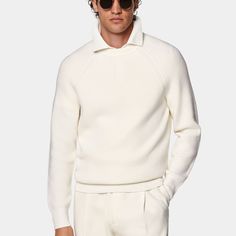 This off-white crewneck sweater is tailored to a slim fit and features a ribbed texture, medium weight, and raglan long sleeves. Fitted White Sweatshirt For Fall, Fitted Winter White Sweater For Workwear, White Sweater With Ribbed Collar For Spring, White Ribbed Collar Sweater For Spring, White Polo Sweater For Work, Long Sleeve Cream Polo Sweater With Ribbed Cuffs, Cream Long Sleeve Polo Sweater With Ribbed Cuffs, Classic White Sweater With Ribbed Cuffs, Classic White Sweater With Ribbed Neckline