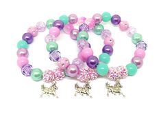 These adorable stretchy bracelets are the perfect favor for your little one's horse themed party! Each bracelet features a Tibetan silver horse charm, resin rhinestone beads and a beautiful assortment of pink, light purple, purple and aqua 10mm acrylic beads strung with durable stretch floss cord. Each bracelet will arrive individually packaged in an organza bag. Please select the amount of bracelets and the size needed from the drop down menus. Exact shade and bead styles will vary. Pink Bracelet For Party Favors, Pink Beaded Jewelry For Party Favors, Adjustable Purple Charm Bracelet For Birthday, Novelty Pink Jewelry With Round Beads, Cute Round Beads Jewelry For Party Favors, Pink Novelty Stretch Bracelet For Birthday, Novelty Pink Stretch Bracelet For Birthday, Novelty Beaded Jewelry For Birthdays, Playful Purple Hypoallergenic Jewelry