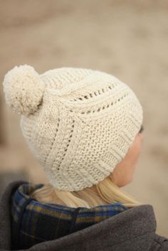 a woman wearing a white knitted hat