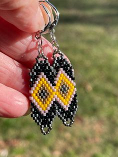 Beautiful hand woven earrings with stainless steel lever back closures:  Matte Black Yellow Silver Purple  Brown   Measures 35mm X 12mm Handmade Black Clip-on Earrings For Gift, Handmade Black Dangle Clip-on Earrings, Artisan Black Dangle Earrings, Handmade Black Hoop Earrings Gift, Artisan Black Beaded Drop Earrings, Handwoven Black Jewelry With Round Beads, Black Artisan Drop Earrings, Artisan Black Drop Earrings, Black Handwoven Artisan Earrings